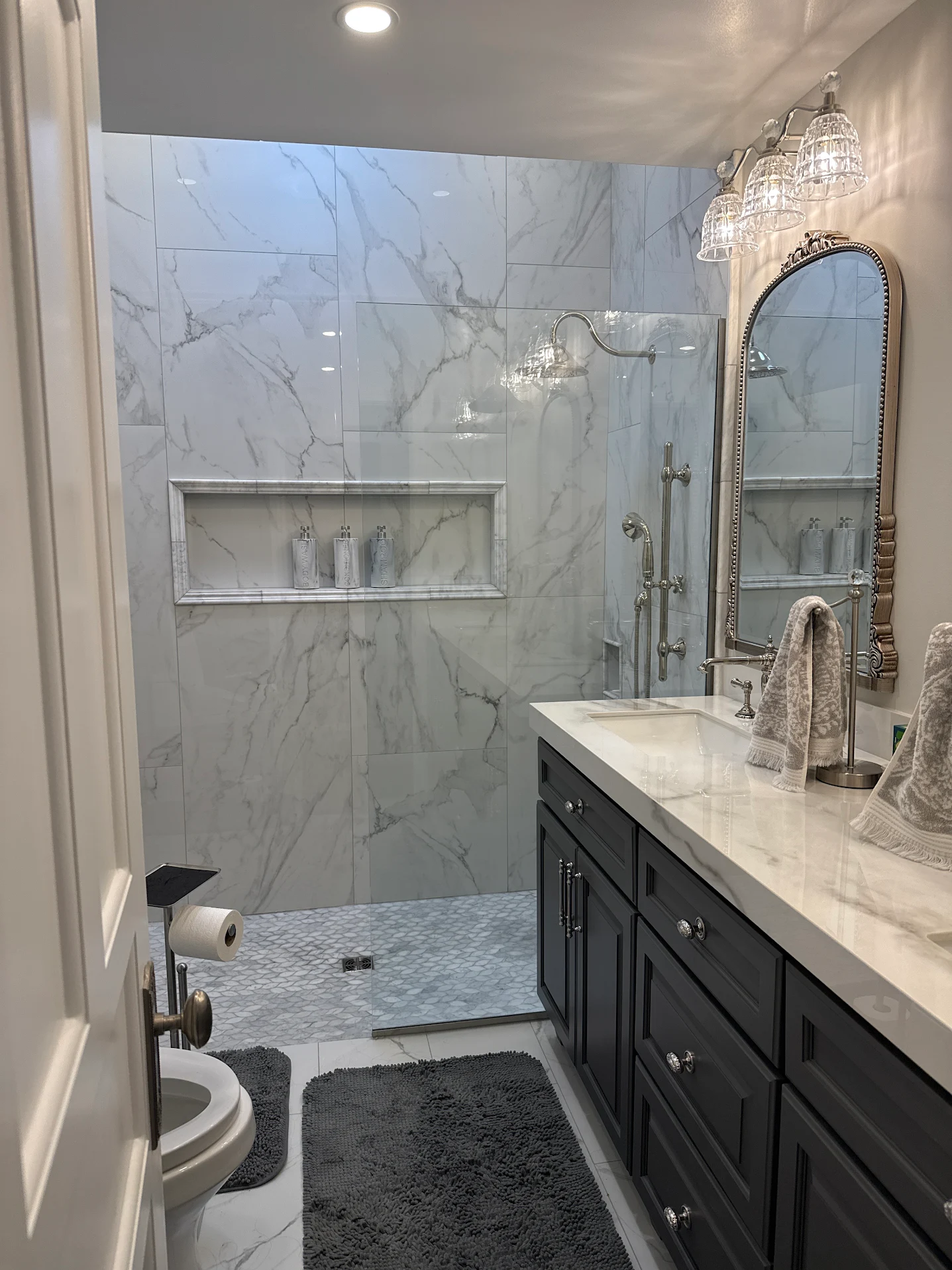 Bathroom remodel with marble shower surround and double vanity
