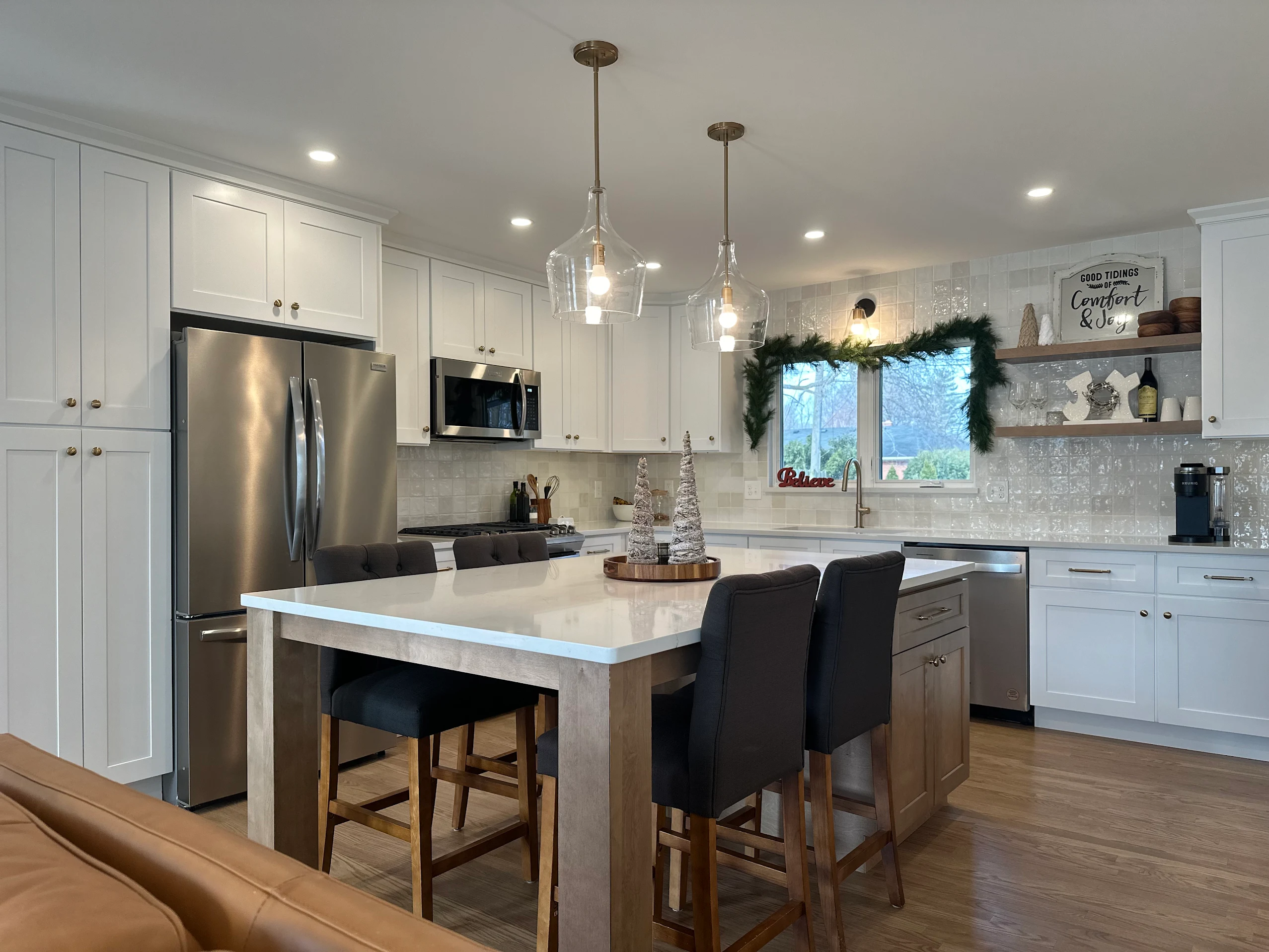 Recently completed kitchen with quartz island and pendant lighting