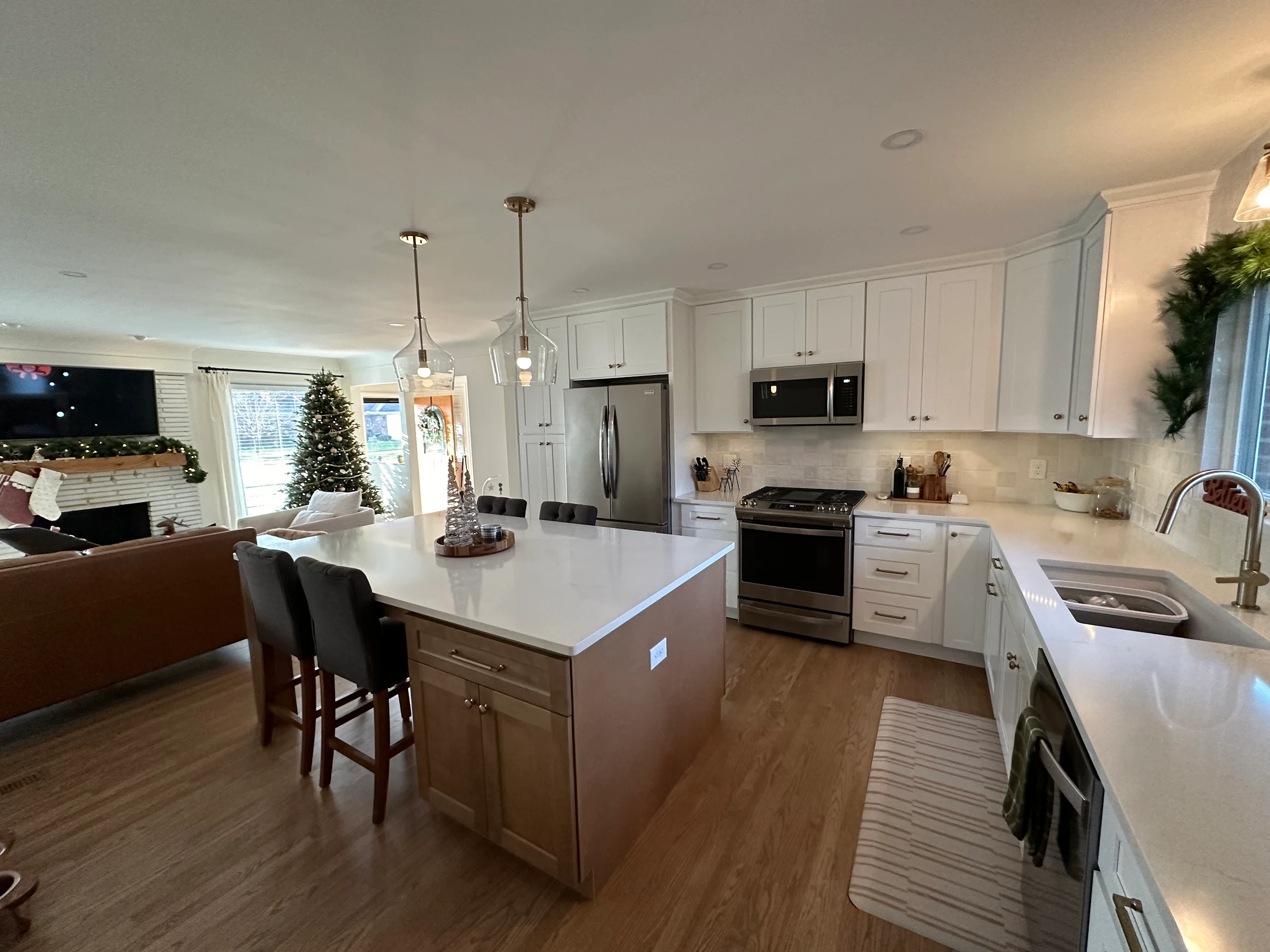Open-concept kitchen remodel with white shaker cabinets and quartz countertops